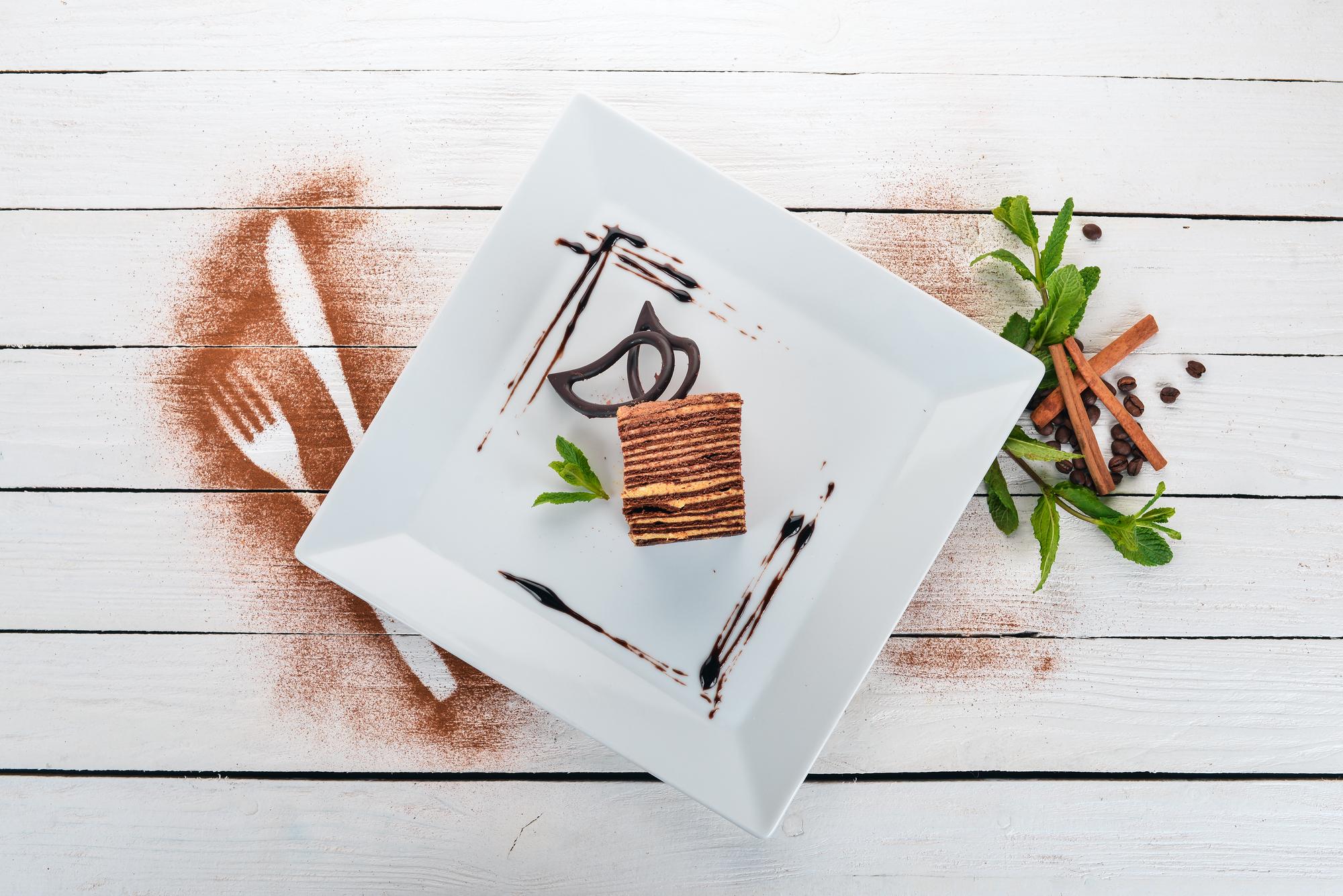 Large editorial shot of plated tasting menu on paper backdrop